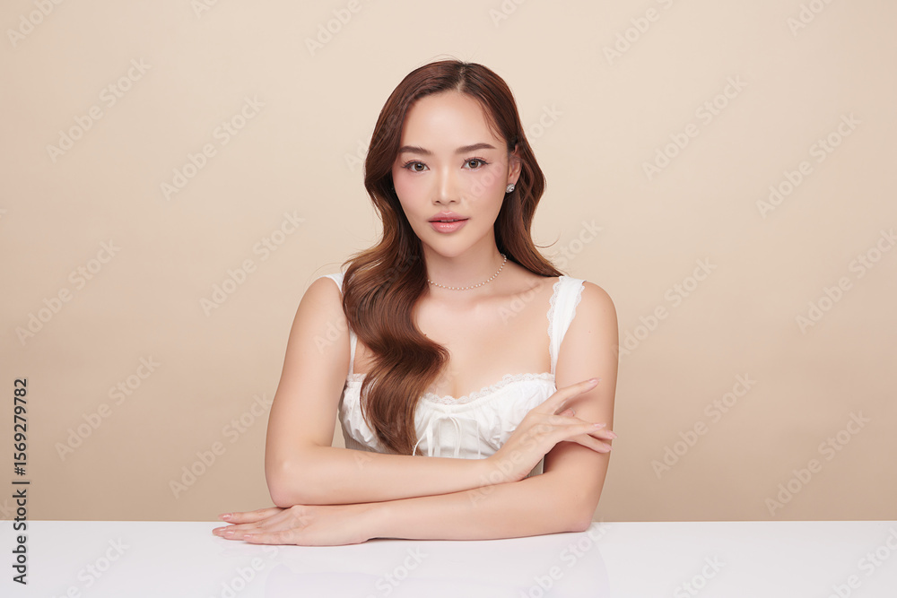 A beautiful young Asian woman with clean, fresh skin against a beige background. Skincare, facial treatment, cosmetology, beauty, and spa. An elegant portrait of an Asian woman. A beautiful young Asian woman with clean, fresh skin against a beige background. Skincare, facial treatment, cosmetology, beauty, and spa. An elegant portrait of an Asian woman.
