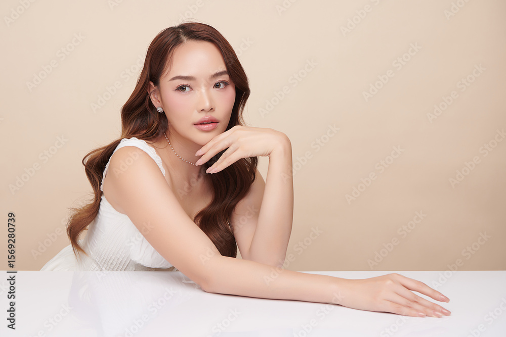 A beautiful young Asian woman with clean, fresh skin against a beige background. Skincare, facial treatment, cosmetology, beauty, and spa. An elegant portrait of an Asian woman. A beautiful young Asian woman with clean, fresh skin against a beige background. Skincare, facial treatment, cosmetology, beauty, and spa. An elegant portrait of an Asian woman.