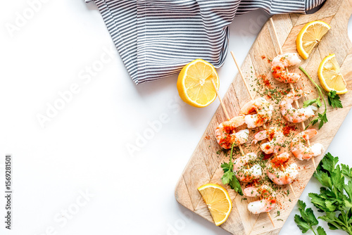 Shrimp skewers - appetizer in mediterranean kitchen - on white table top view copy space