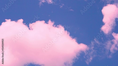 Pink Puffy Cotton Cloud Floating Across Blue Lilac Sunset Sky Left to Right Time Lapse, Slow Motion. Beautiful Colorful Sky Clouds Background, Colored Dreamy Atmosphere, Aerial View, Heaven.