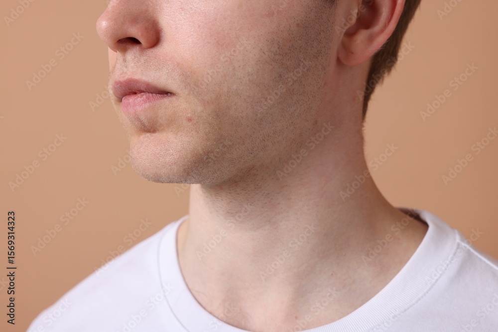 Fototapeta premium Man after shaving on beige background, closeup
