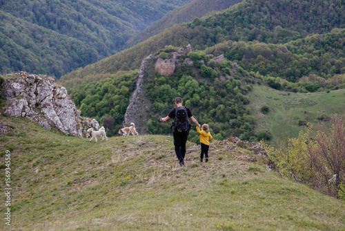Wallpaper Mural Cute toddler in a yellow jacket enjoying and playing in the mountains at sunset. Little explorer learning through play.  Torontodigital.ca