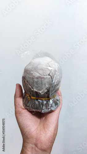 A hand holds an asin tibuok which is a rare Filipino artisanal sea salt which is a local product from Bohol, Philippines that celebrates heritage and culture
