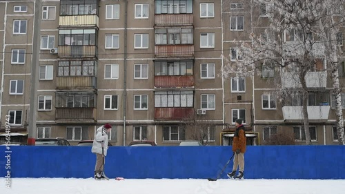 People skate and play ice hockey in the yard