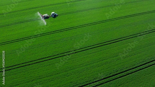 Aerial View of Tractor Spraying Green Field