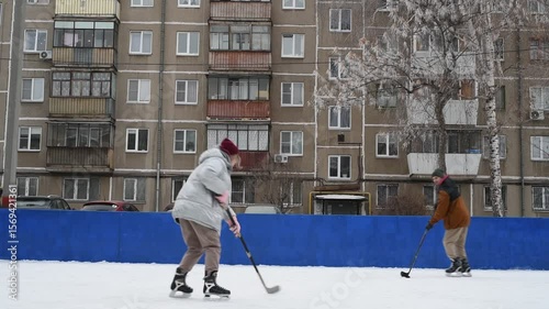 People skate and play ice hockey in the yard