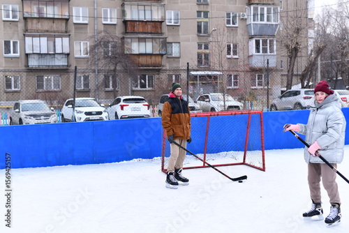 Photography People skate and play ice hockey in the yard