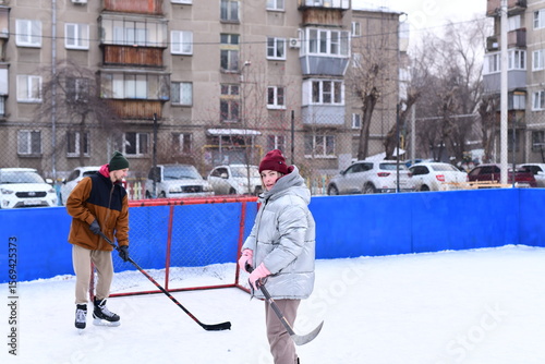 Photography People skate and play ice hockey in the yard
