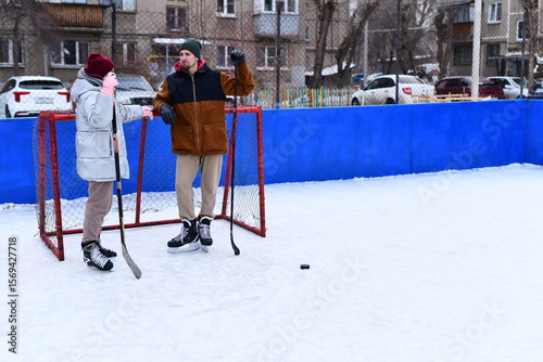 Photography People skate and play ice hockey in the yard