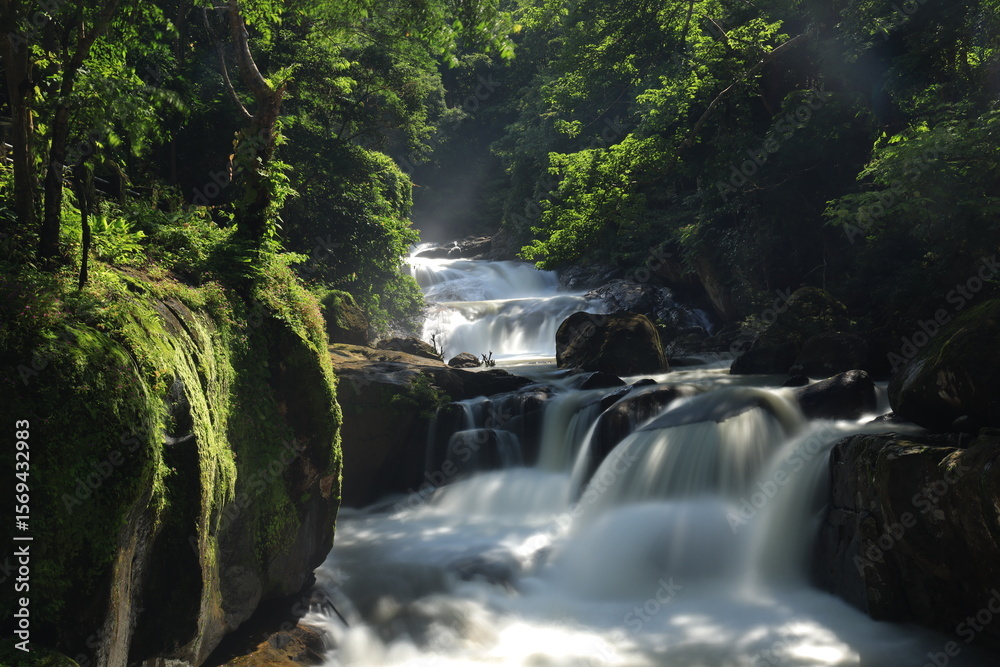 Naklejka premium Nang Rong waterfall is a multi-tiered waterfall plunges down to several rock formations below, and then flows into the lush surrounding forests ,Nakhon Nayok province ,Thailand
