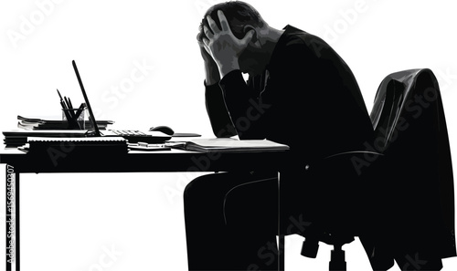 A stressed businessman sits at his desk with his head in his hands, isolated on white background