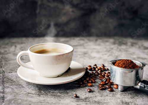 Aromatic Coffee cup and beans with ground coffee on Portafilter, Espresso coffee cup aromatic and making equipment
