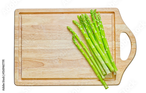 Isolated wooden cutting board with Asparagus on white background. Flat lay design.