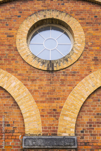 Close up of curved brickwork and circular window
