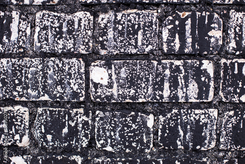 Old brick black color wall background. Dark stone texture