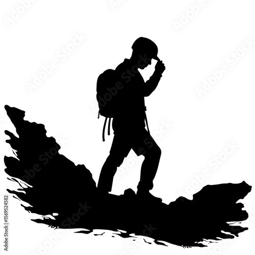 Silhouette of hiker adjusting helmet on rocky terrain, outdoor adventure safety