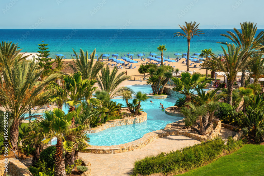 Fototapeta premium A beautiful resort with a pool overlooking a stunning beach and the ocean.