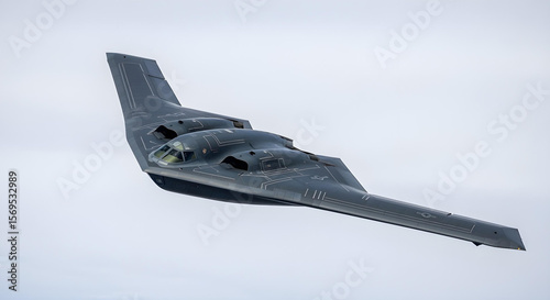 B-2 stealth bomber flies against pale sky, wide-angle view