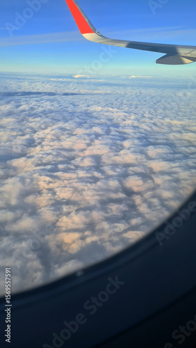 Bild auf Leinwand Aerial view of fluffy white clouds with a glimpse of blue sky