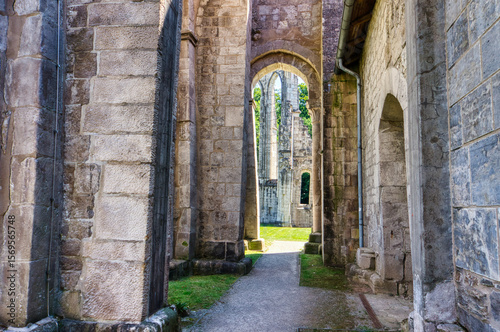 Medieval ruins of the Cistercian Walkenried Monastery in Lower Saxony, Germany. Gothic arches, stone walls, and green lawns under a clear blue sky reflect centuries of religious history