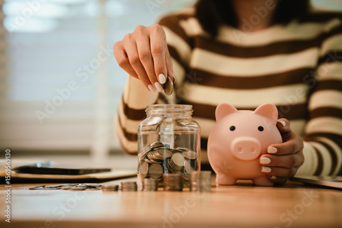 A woman holds a piggy bank, which symbolizes savings, financial planning, and economic challenges. Budgeting, investing, and money management for a secure future.