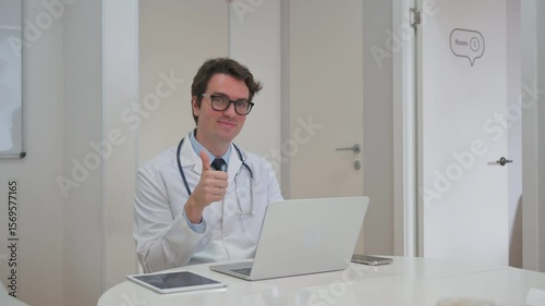 Wallpaper Mural Thumbs Up by Young Doctor Working on Laptop Torontodigital.ca