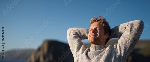 The man enjoying the serene beauty of nature and the warmth of sunlight.