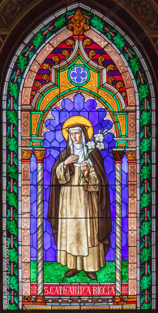 Fototapeta premium PRATO, ITALY - MARCH 21, 2025: The stained glass with St. Catherine de' Ricci in the Cathedral by unknown artist of 19. cent. 