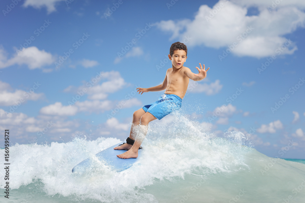 Asian boy riding a surfboard Asian boy riding a surfboard