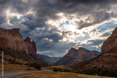Dramatic Cloudy Sky Over Rocky Mountains in Scenic Valley Landscape.