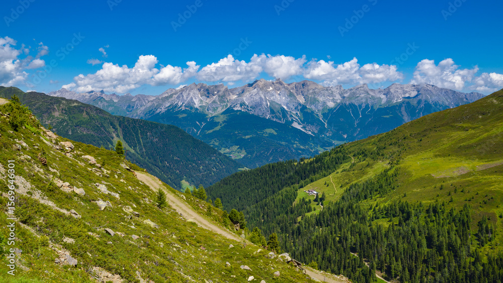 Fototapeta premium Summer landscape in mountains and blue sky with clouds. Location place Alps, Tyrol, Austria, Europe.