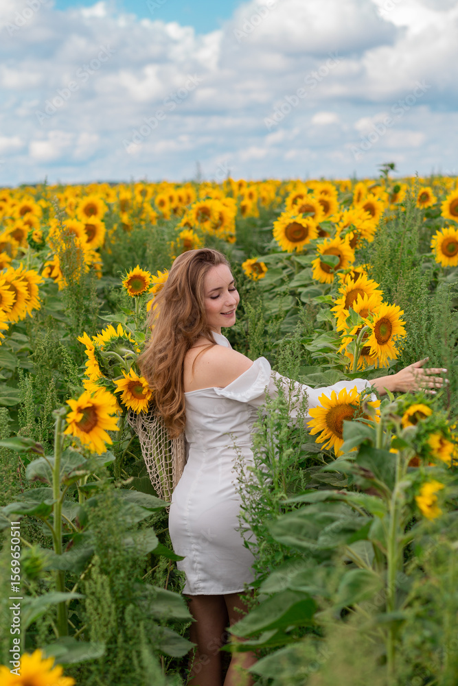 Fototapeta premium girl in white dress in sunflower field