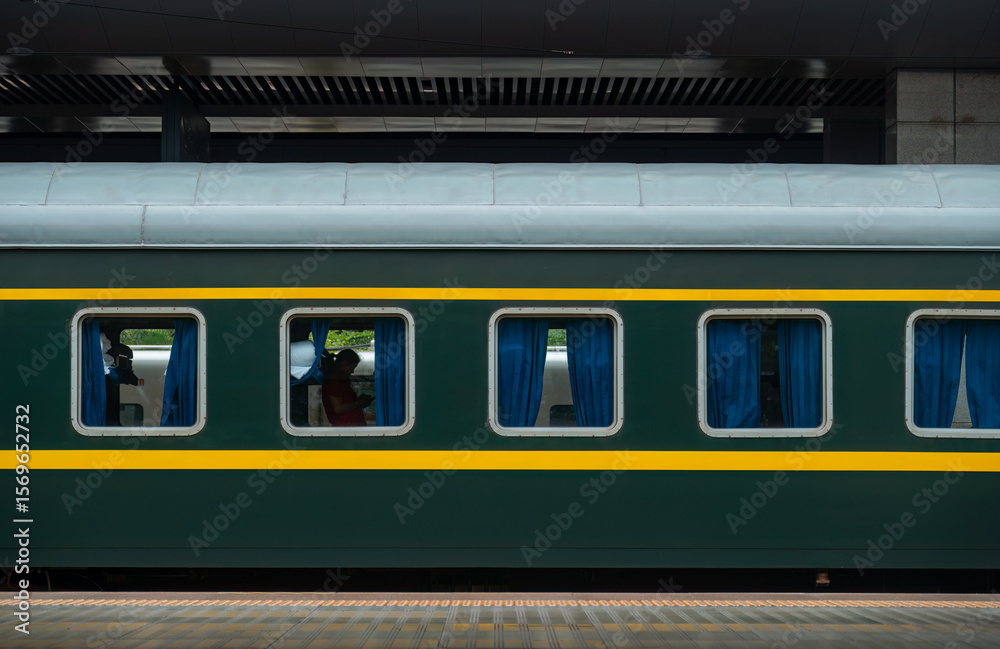 Fototapeta premium China Railway, green train coach docked at the platform