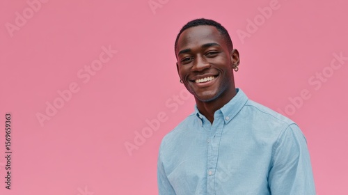 Happy African American Man Smiling Cheerfully Against Pink BackgroundStudio Portrait