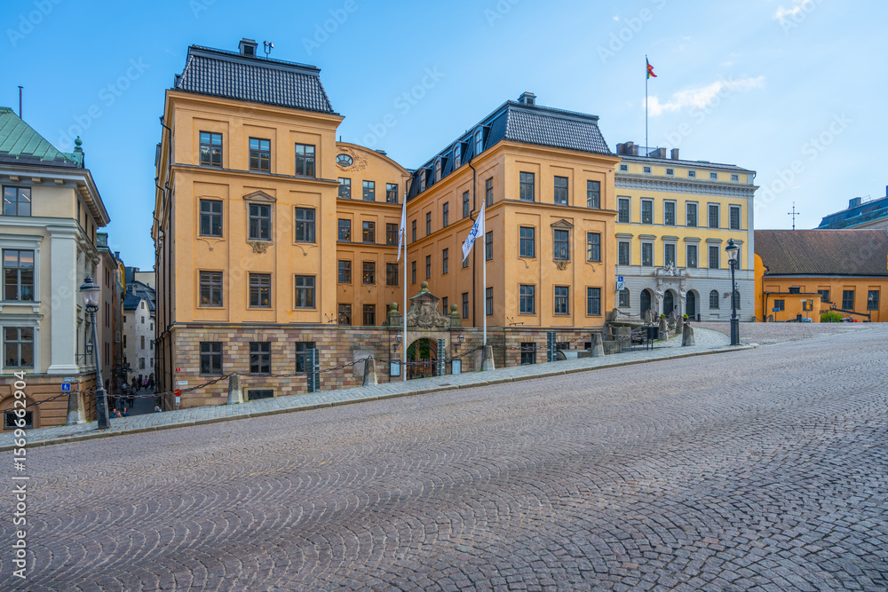 Obraz premium A view of the Kammarkollegiet, the Swedish Legal, Financial and Administrative Services Agencys headquarters, showcasing its traditional yellow facade on a clear day. Stockholm, Sweden