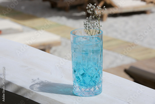 Blue Lagoon Cocktail, Angelo azzurro cocktail in tall glass on the table in the beach bar	