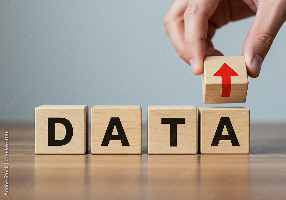 Naklejka premium Data analysis and management concept with wooden blocks showing data and an upward arrow on top block