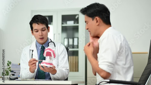 A professional dentist uses a detailed dental model to educate a patient about teeth care and oral health in a bright clinic setting, illustrating hygiene 