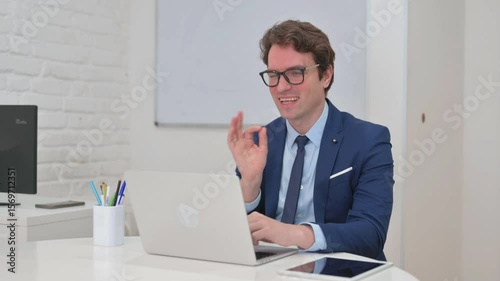 Doing Video Chat with Client by Mature Adult Businessman