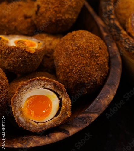 Fotografija Beautiful scotch eggs in wooden bowl, crispy outside, soft and tender inside