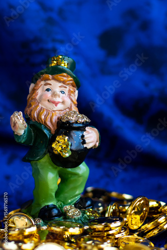 Small leprechaun on top of several small golden coins. 