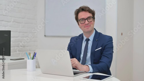 Businessman Reacting with Surprise at Desk