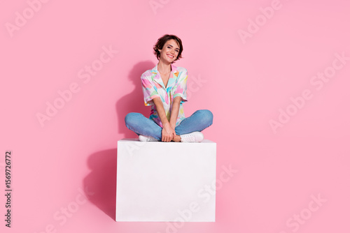 Full size photo of pretty young lady sit cube wear shirt isolated on pink color background