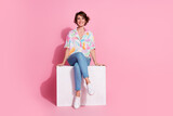 Full body portrait of nice young woman sit podium empty space wear shirt isolated on pink color background