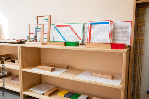 Montessori material. Wooden shelf with materials for Montessori studies