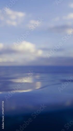 Wallpaper Mural Calm ocean waters stretch to the horizon, under a bright blue sky adorned with a few fluffy clouds. It is a tranquil afternoon by the sea, inviting serenity and reflection. Torontodigital.ca