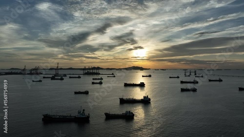 Aerial view oil tanker ship and gas tanker ship at sunset, Silhouette oil and gas tanker ship at oil and gas terminal, Global business import export logistic transportation oil and gas petroleum.