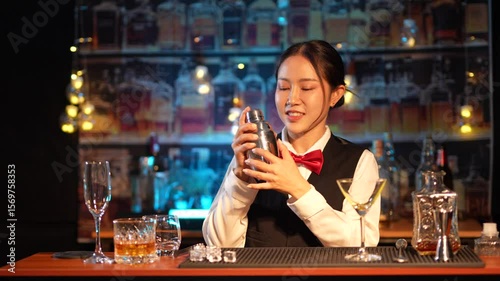 Professional female bartender preparing alcoholic drinks in a bar