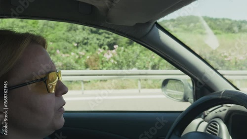 Young Woman is Driving a Car