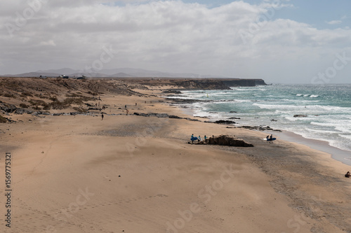 Wallpaper Mural Vista panorámica de Piedra Playa con surfistas en el mar, en El Cotillo, Fuerteventura Torontodigital.ca